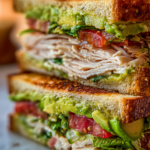 restaurant style turkey avocado club sandwich on toasted sourdough